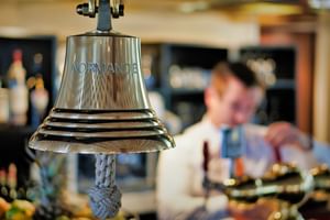Ship's bell at the bar, MS NORMANDIE